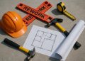Construction site with blueprints and tools illustrating tips to prevent project reworks