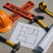 Construction site with blueprints and tools illustrating tips to prevent project reworks